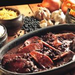 Feijoada. Black beans cooked with pork. You dare with a "caipirinha"? 